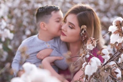 Close-up of mother and daughter amidst plants