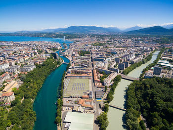 High angle view of townscape by river against sky