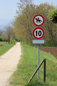 Pedestrian street with no access to horses and road sign with speed limit