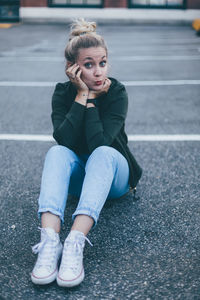 Young woman sitting on floor