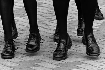 Low section of people standing on footpath