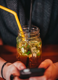 Close-up of woman with drink on table