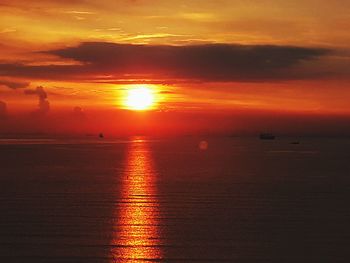 Scenic view of sea against romantic sky at sunset