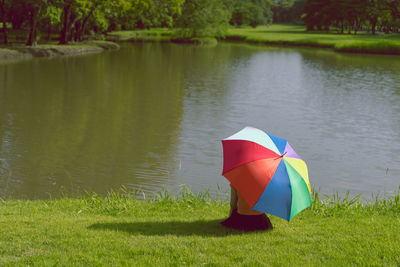 Multi colored umbrella on lake