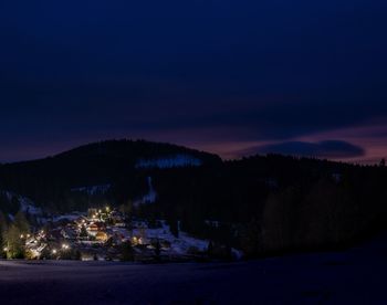 Scenic view of landscape against sky at night during winter