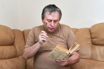 Young man sitting on sofa