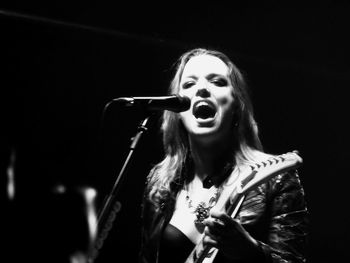 Portrait of singer with guitar performing during concert