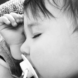 Close-up of cute girl sleeping on bed at home