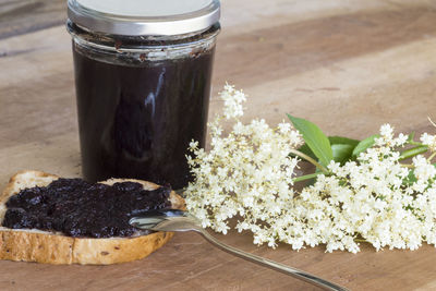 Close-up of white flowers in jar on table