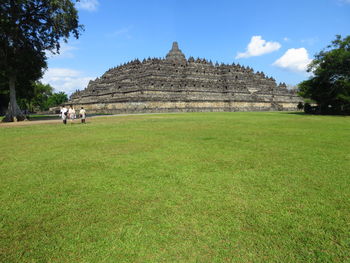 View of temple on field against sky