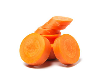 Close-up of orange fruit against white background