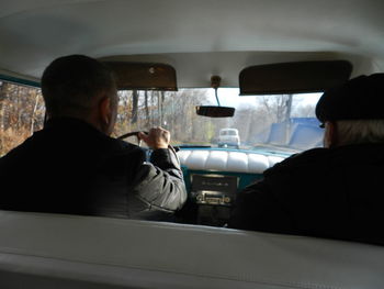 Rear view of man sitting in car