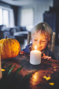 Boy looking away at illuminated table