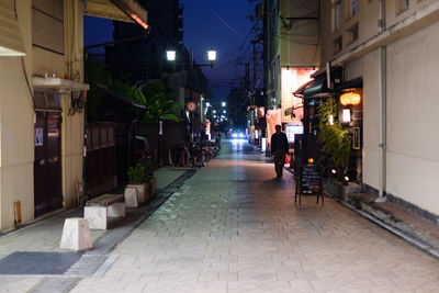 Man in illuminated city at night