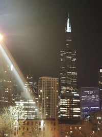 Low angle view of modern buildings against sky at night