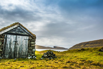 An old abandoned hamlet in the faroe islands. mountains and lake on background. high quality photo