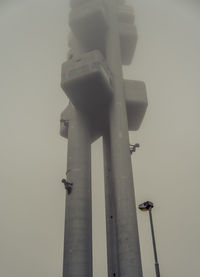 Low angle view of communications tower against sky