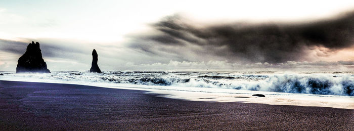 Scenic view of beach against sky during sunset