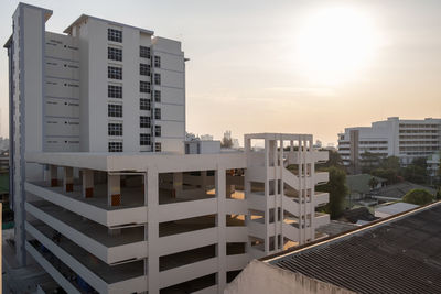 Buildings in city against sky during sunset