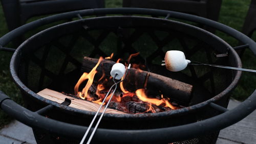 High angle view of marshmallows cooking over fire pit