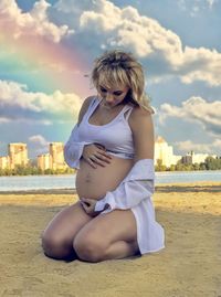 Full length of woman sitting on land against sky