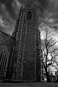 Low angle view of building against cloudy sky