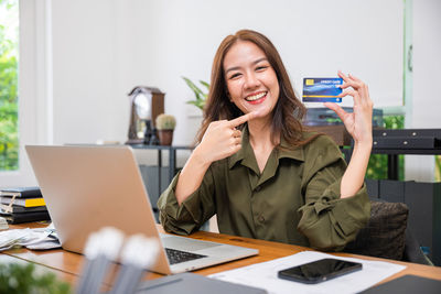 Portrait of young businesswoman working on table