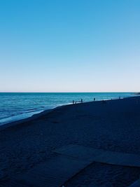 Scenic view of sea against clear blue sky