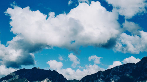 Low angle view of clouds over mountain