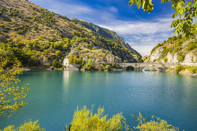 Scenic view of lake and mountains against sky