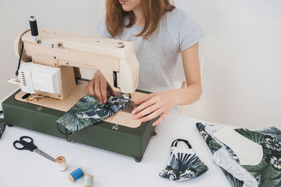 Midsection of woman working on table