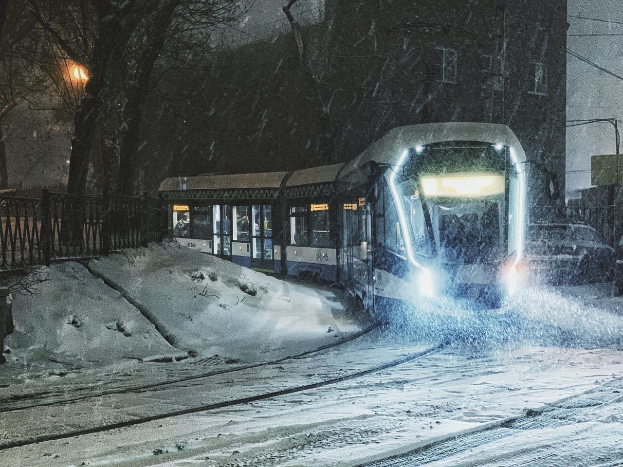 SNOW ON ROAD AT NIGHT