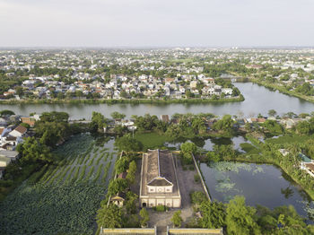 High angle view of buildings and sea against sky