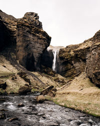 Low angle view of waterfall against sky