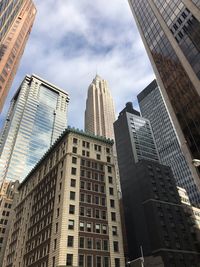 Low angle view of buildings against cloudy sky