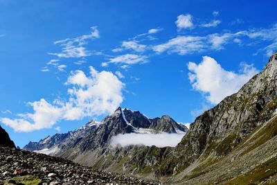 Scenic view of snowcapped mountains against blue sky