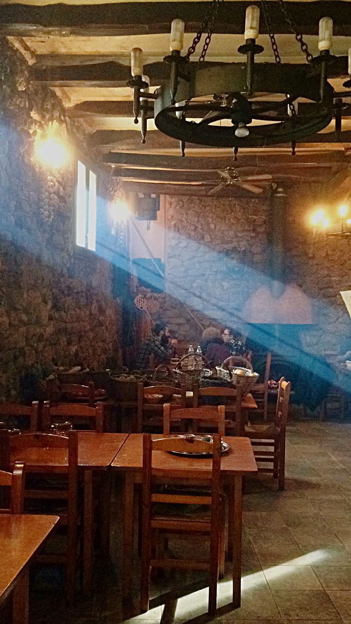 EMPTY CHAIRS AND TABLE IN CAFE