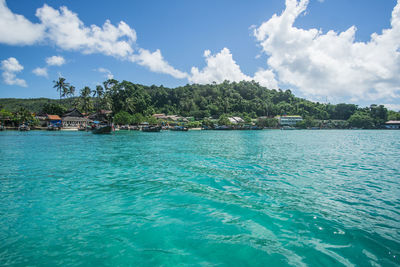 Scenic view of sea and buildings against sky