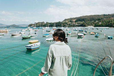 Rear view of woman looking at sea against sky