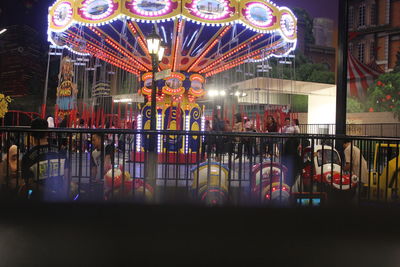 Group of people at amusement park ride at night