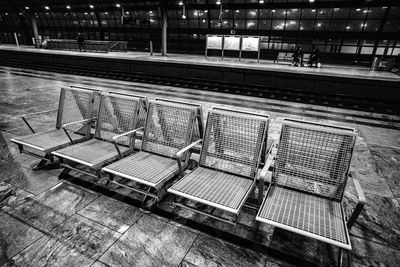 High angle view of empty bench at railroad station