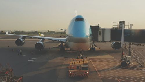 Boarding passageway connected to airplane door at terminal