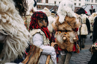 People in street in city during winter in costumes