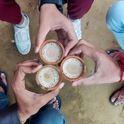 Team gathering at a tea spot holding tea pots full of tea