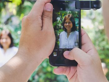 Midsection of woman using mobile phone