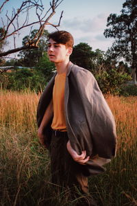 Young man standing on field