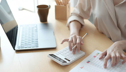 High angle view of woman using laptop on table