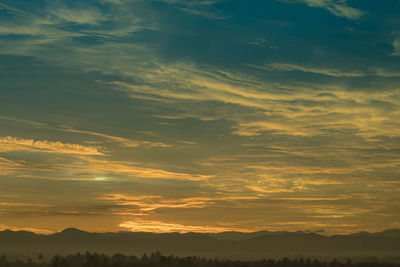 Scenic view of silhouette mountains against sky during sunset