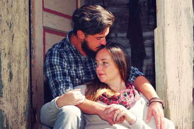 Young couple sitting outdoors