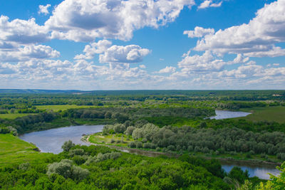 Scenic view of lake against cloudy sky